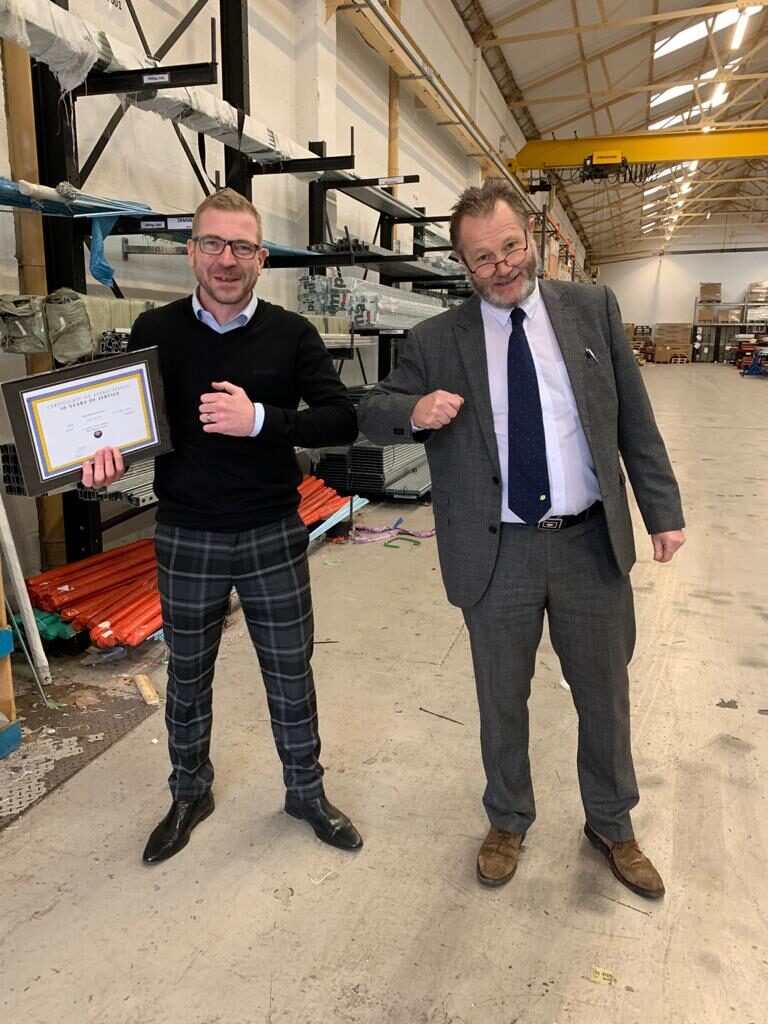 Craig Wyatt receiving his 10 years of service award from Tony Smith